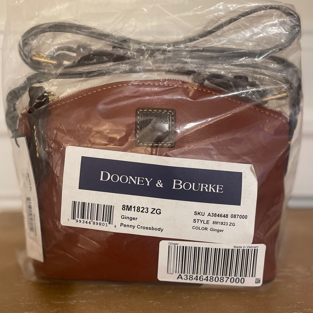 New. Never used. Dooney & Bourke leather Penny Crossbody Bag Ginger color